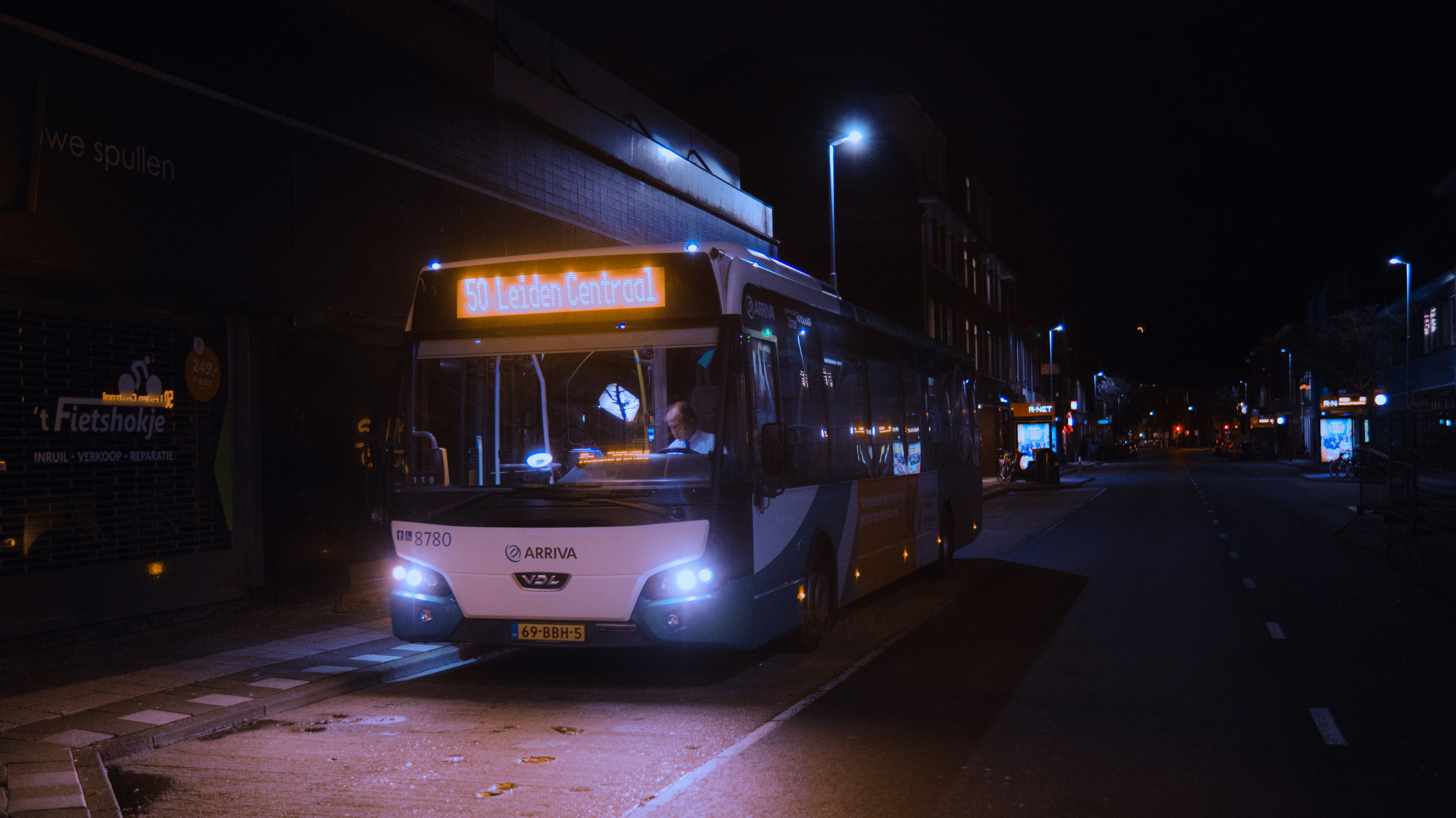 white and red bus on road during night time